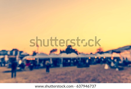abstract blur image of retail shop at day festival for background usage . (vintage tone)