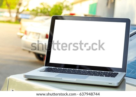 White Screen Laptop on sedan car in the parking lot. Concept for insurance, marketing and finance.  