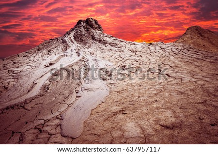 Sunset over muddy volcanoes, Buzau county, Romania. Active mud volcanoes landscape in Europe.