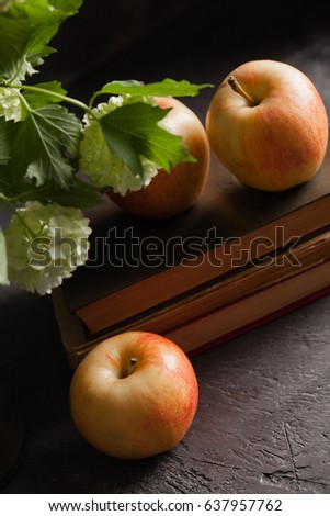Apples on books on a dark background