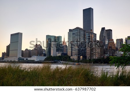 United Nations building and Manhattan skyline in sunset with a cloudless sky seen from Roosevelt Island