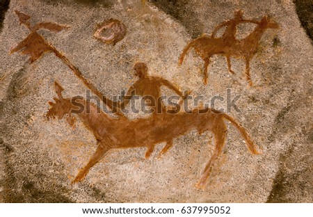 Drawing of an ancient man in a cave depicting a rider. A rider with a flag in his hand. Petrographic. history. archeology.