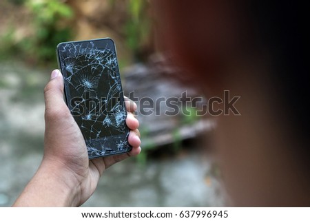 man holds a out-of-use tablet or smartphone