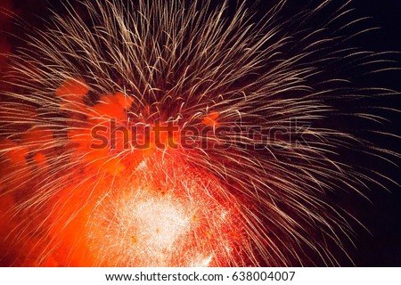 Red and white fireworks in the dark sky