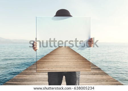 Man holding surreal painting of a boardwalk Royalty-Free Stock Photo #638005234