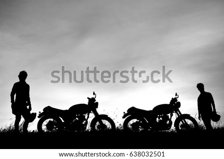 Beautiful silhouette of two motorcycle riders in black and white picture style.