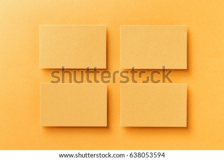 Mockup of four horizontal business cards at golden foil paper background.