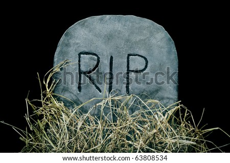 closeup of a grave in a cemetery at night for Halloween