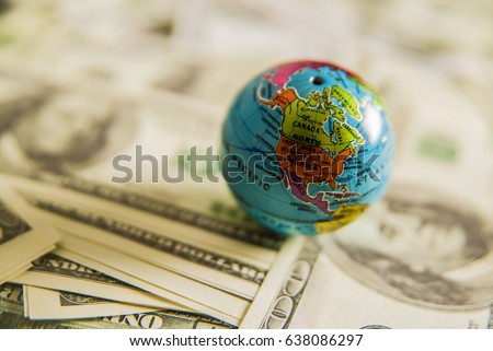 a globe map and cash - hundred dollar bills close up. empty copy space for inscription.