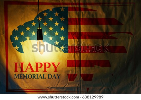 Memorial Day with eagle in national flag colors on fabric illuminated by a light bulb