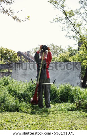 mowing trimmer - worker man repair the string trimmer
