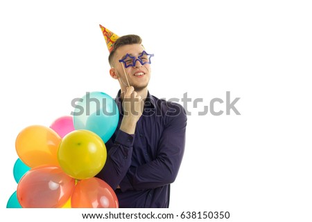 funny young guy in glasses holding a balloons