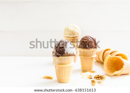 Vanilla and Chocolate Ice Cream Scoops in Waffle Cup Cones on Light Background