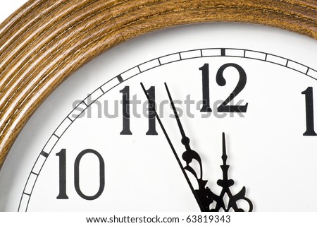 Modern wall clock shows almost twelve