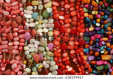Colored Precious Stones Jewelery on a Wooden Background                         