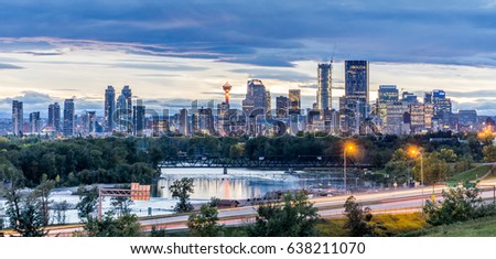 Calgary downtown in the evening at sunset with Bow River  Royalty-Free Stock Photo #638211070