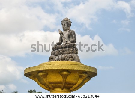 Buddha carved stone In the garden of Dharma.