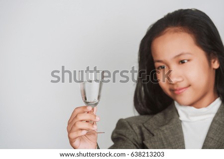 Close-up of pretty teen girl drinking water from glass