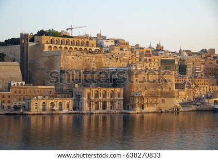 The view of Valletta fortifications with Fort Lascaris and Upper and Lower Barrakka Gardens  from the water of Grand Harbour. Malta