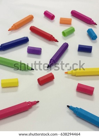 Colored markers  pen and sleeve spread isolated on white paper background, Set of multicolored color pen which selected focus on pink and blue pen with blur background
