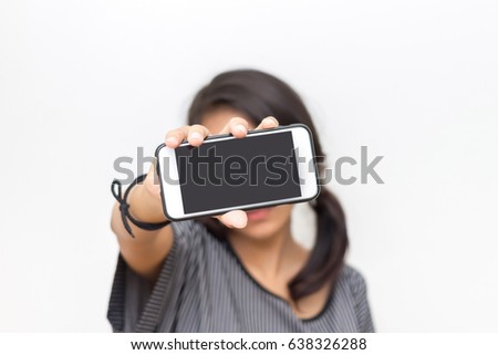 Portrait of a young woman holding a smartphone