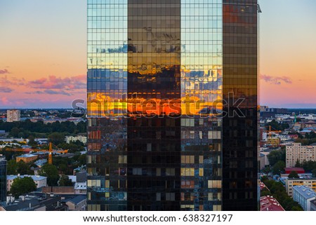 Modern business building reflects fire of sunset