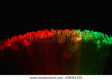 Blurred LED screen closeup. Glowing threads in a color spectrum on a black background. Bright abstract background ideal for any design                                
