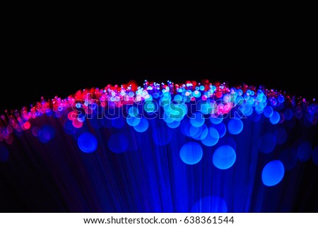 Blurred LED screen closeup. Glowing threads in a color spectrum on a black background. Bright abstract background ideal for any design                                
