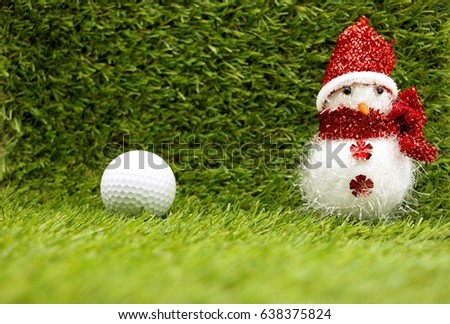 golf ball with snow man for Christmas on green grass