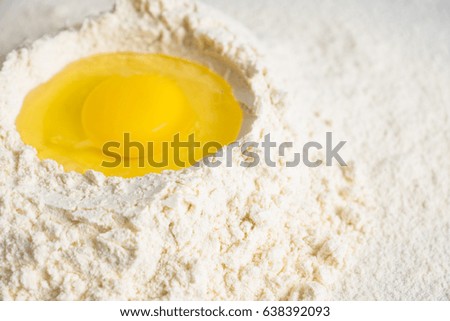 Flour and egg on the white table. Selective focus.