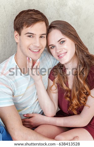 Young couple in love. Couple supporting each other and relying on each other having nice time together. Young happy woman hugging her handsome boyfriend. Portrait of cheerful casual people in love