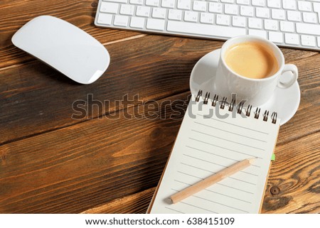 working place at wooden desktop with coffee