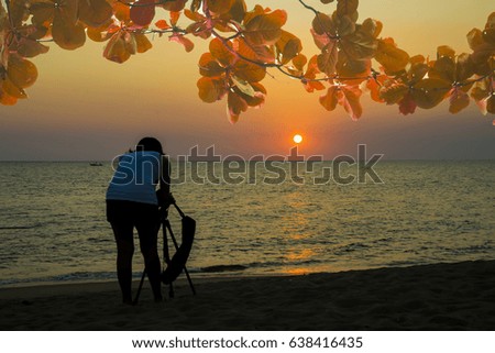Silhouette female photographer at sunset Natural background
