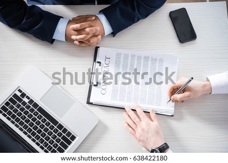 top partial view of businessman signing contract at workplace