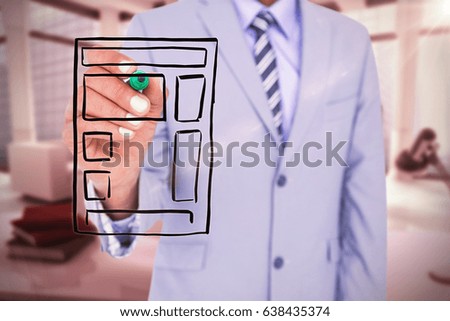 Midsection of businessman writing with marker against computer generated image of workplace