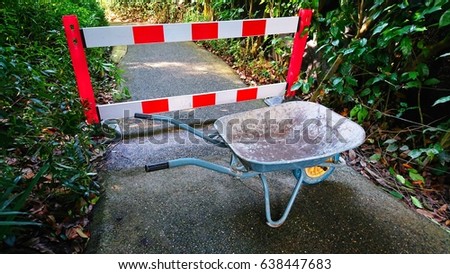 Plastic detachable construction barrier is used to block footpath under repair. The cement has to let dry and settle before the path is opened for use. 