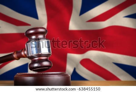 Hammer and gavel against 3d digitally generated great britain national flag