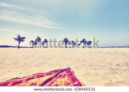 Vintage toned picture of a beach, summer holidays concept, focus on palm trees.
