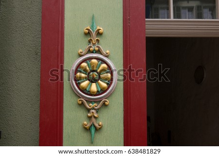 vintage  decoration on a wooden panel on a house facade
