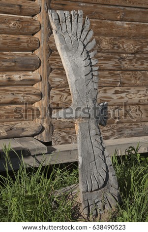 The wooden eagle in front yard. Russia, village.