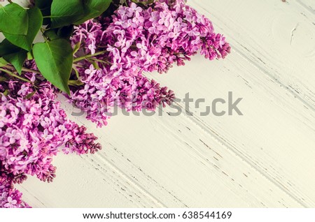 Beautiful spring flowers lilac on white wooden vintage board with place for text. Syringa vulgaris. Happy Mother's Day greetings card. Top view. Copy space.