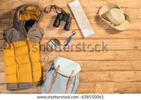 Traveler set on wooden background, flat lay