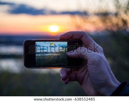 Hand photographes phone sunset landscape sunlight summer