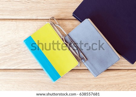 Three books on wood background