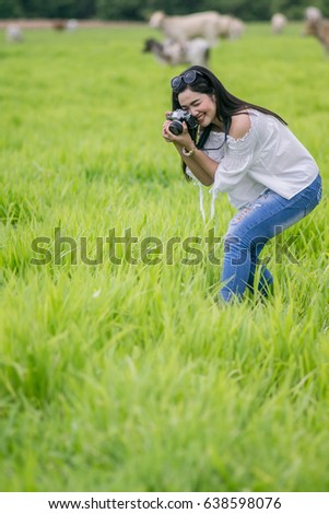 Women are taking photos in the meadow