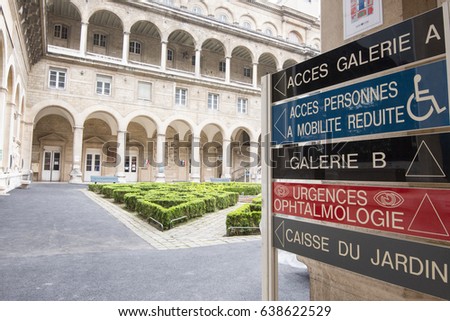 Garden of the Hospital Hotel-Dieu in Paris with signs