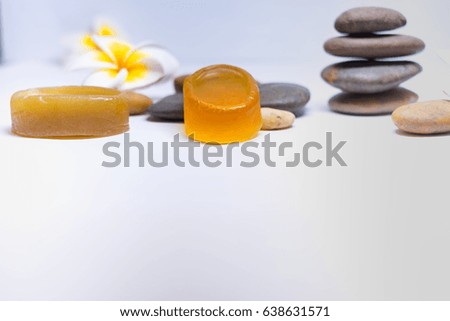 spa concept, natural soap and round stone on white background