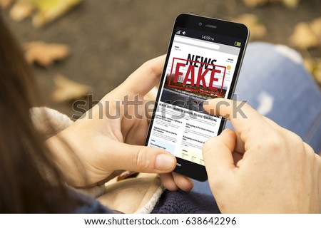 media technology and modern lifestyle concept: young woman with smartphone reading fake news at the park Royalty-Free Stock Photo #638642296