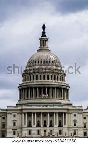 A high contrast close up of the dome of the US Capitol Dome on an overcast day.