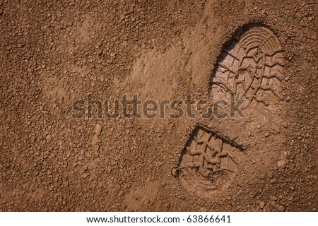 Imprint of the shoe on mud with copy space Royalty-Free Stock Photo #63866641